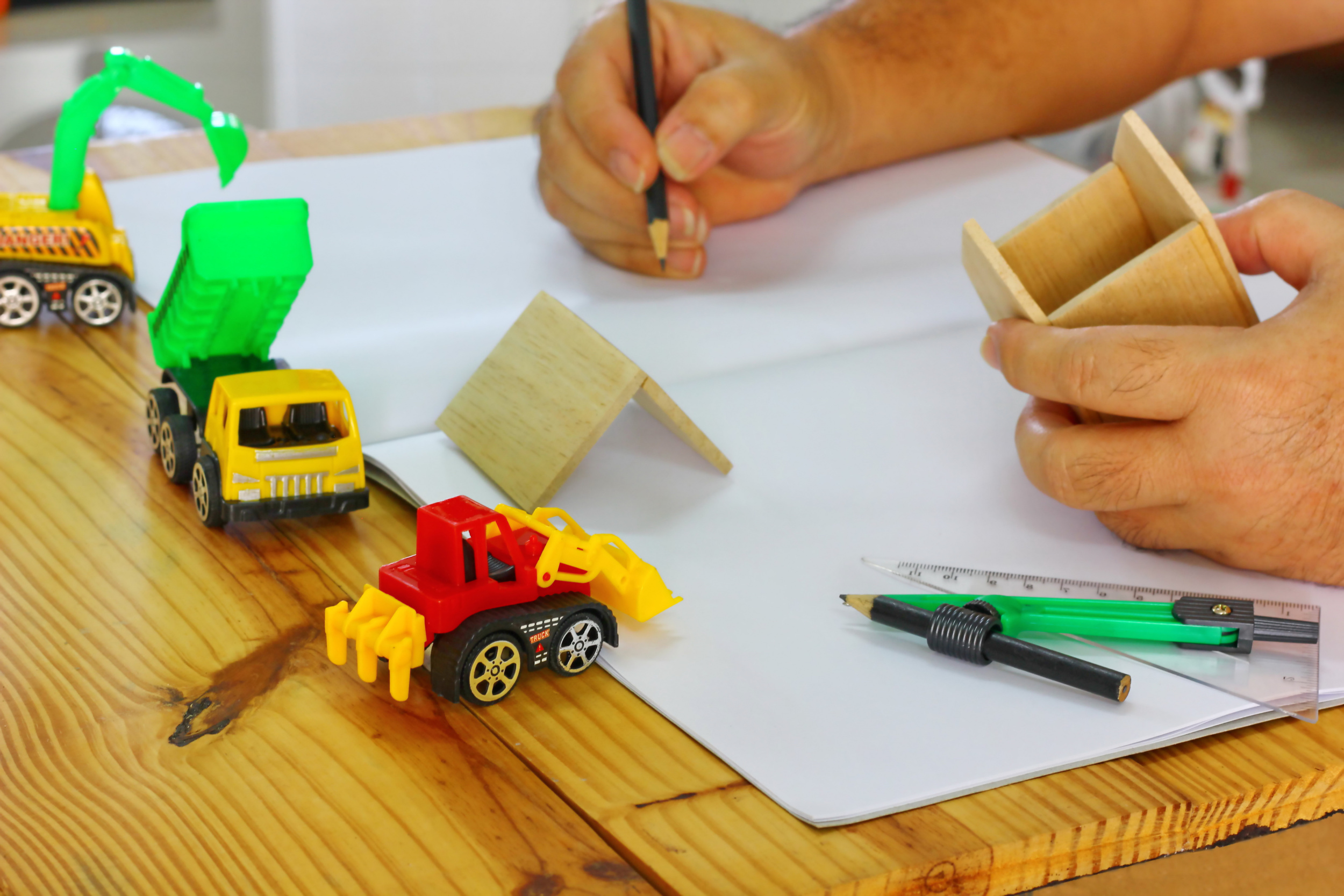 1 architect-home-designer-builder-table-wood-home-modle-with-drawing-tools-with-construction-heavy-machine-wood-table-hand-is-design-new-home-devenlope-from-wood-modle.jpg