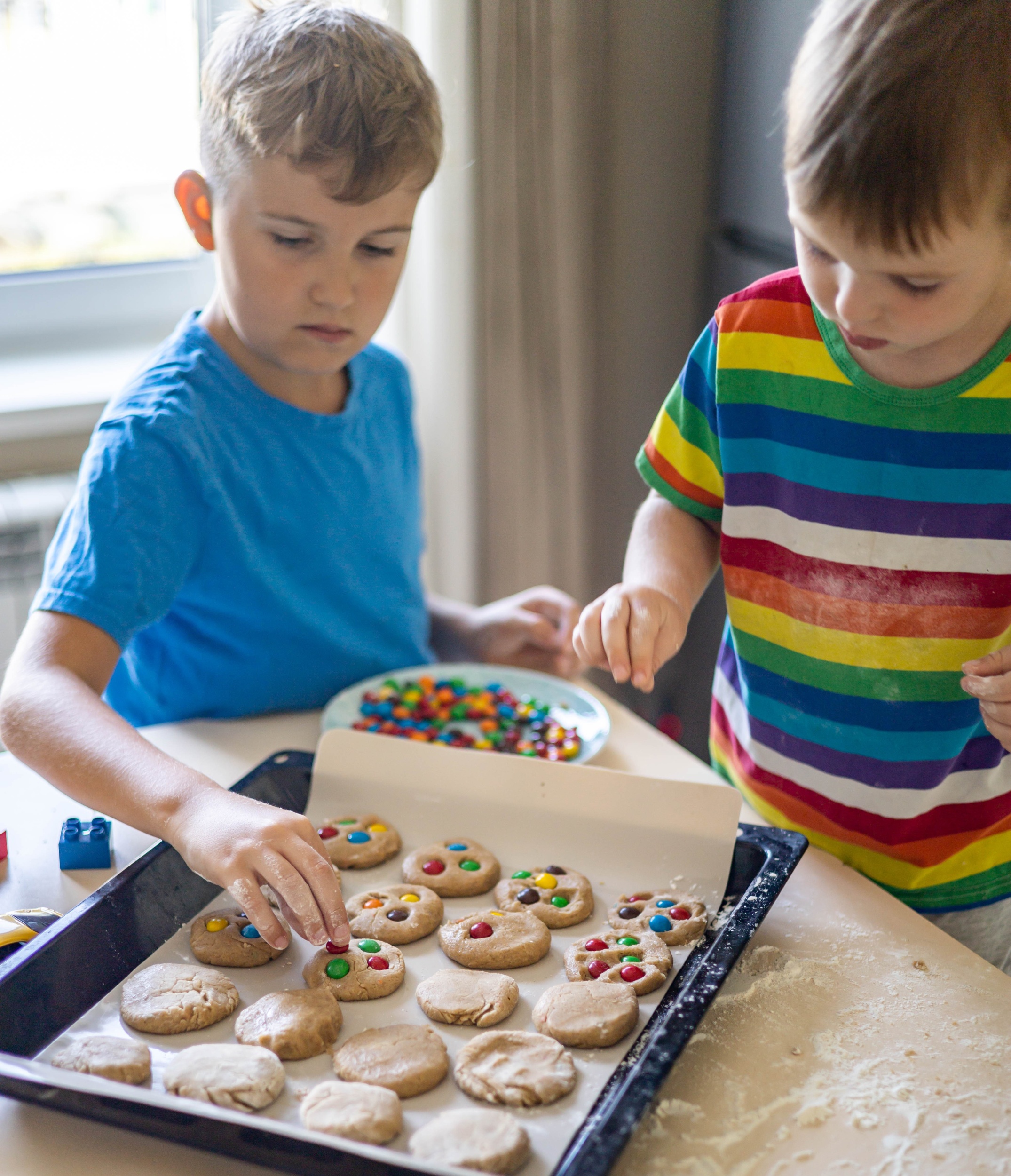 3 funny-brother-male-kids-rejoicing-having-fun-cooking-dessert-with-with-multicolored-round-chocolates-mm.jpg