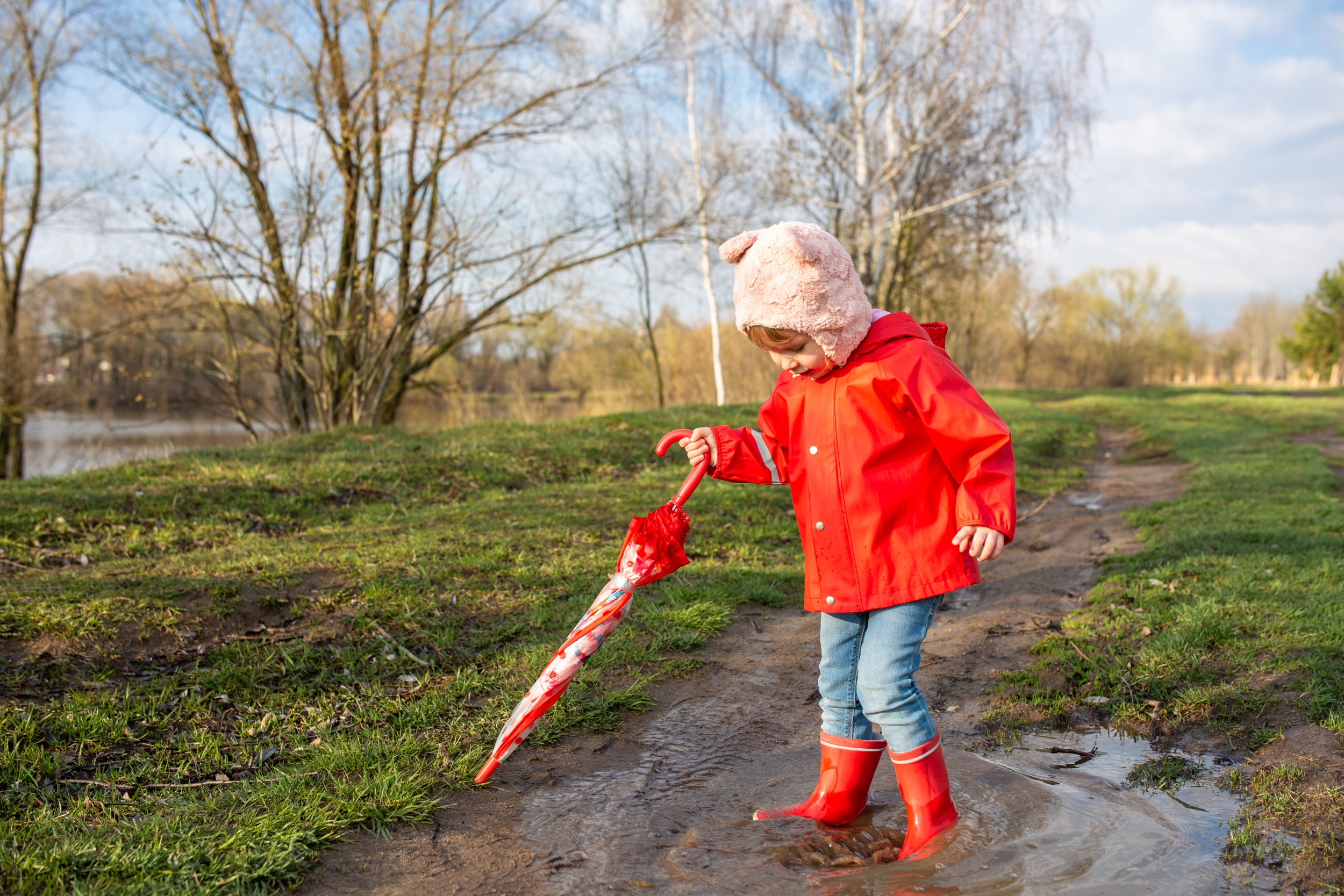 child-plays-with-umbrella-after-rain-red-rubber-boots-raincoat.jpg