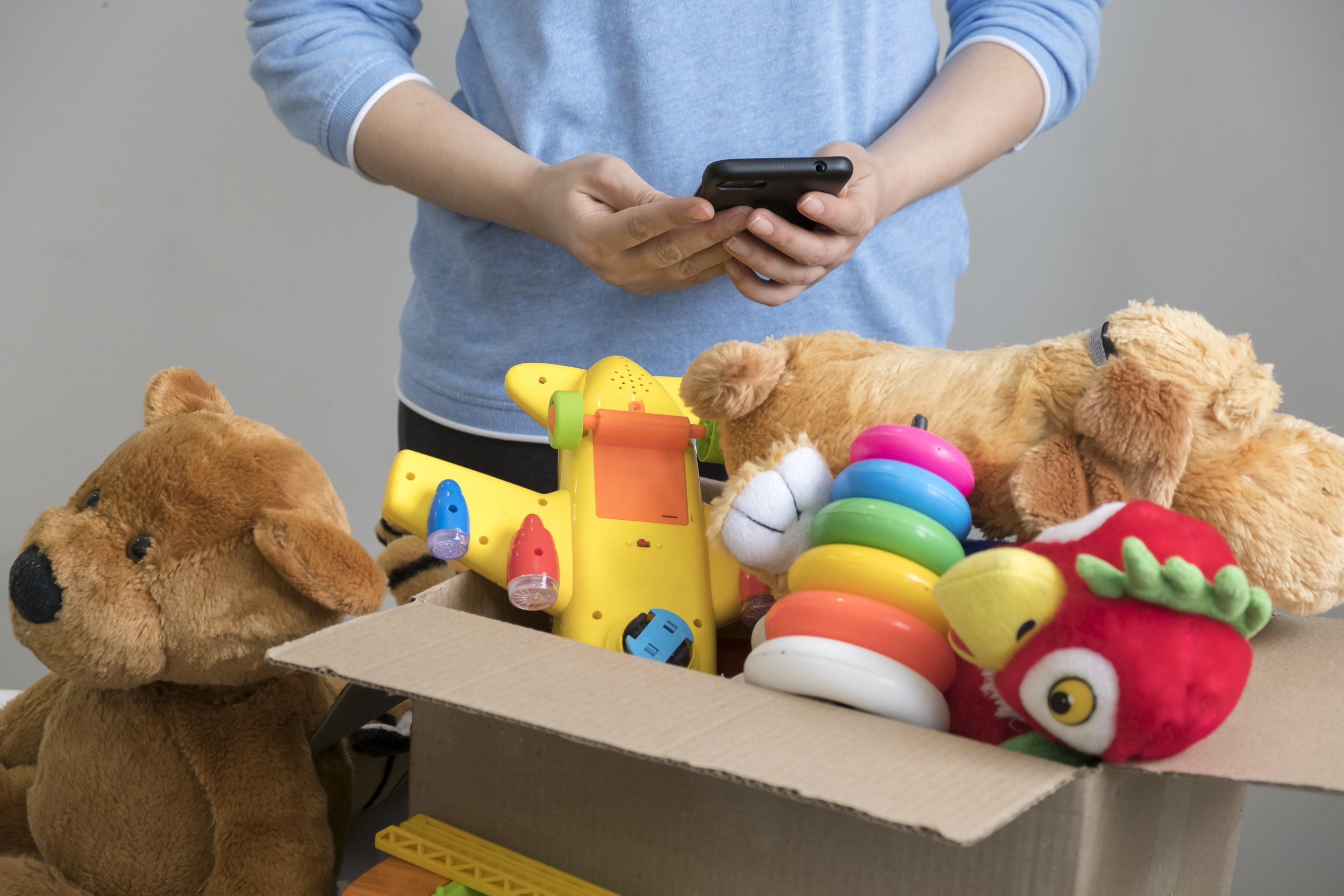 volunteer-holding-donation-box-with-old-toys.jpg